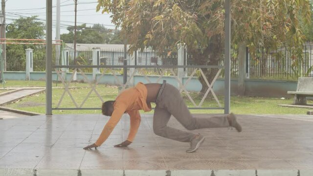 Epic breakdancing in a tropical park setting from a b boy