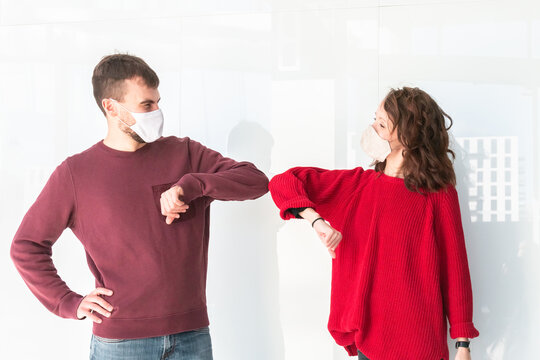 Man and woman greeting with elbow bump