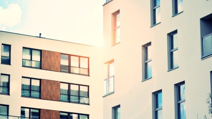 Apartment residential house and home facade architecture and outdoor facilities. Blue sky on the background. Sunlight. Retro filter.