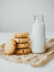 Delicious homemade peanut butter cookies with mug of milk, on white background. Healthy breakfast concept.