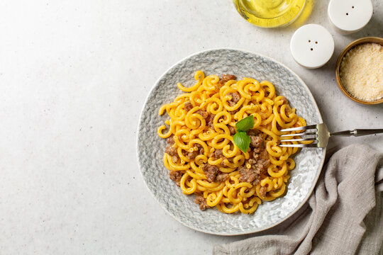 Pasta Gramigna whith sausage - gramigna alla salsiccia. Classic italian food. Top view. Copy space.