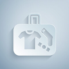 Obraz premium Paper cut Suitcase for travel icon isolated on grey background. Traveling baggage sign. Travel luggage icon. Paper art style. Vector