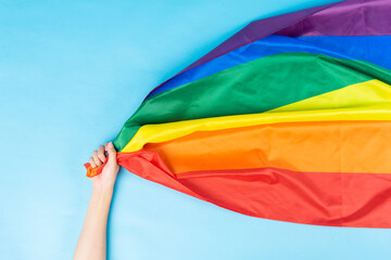 hand is holding the rainbow flag
