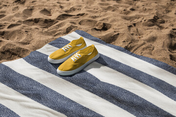 Yellow sneakers on beach towel summer vibes photography