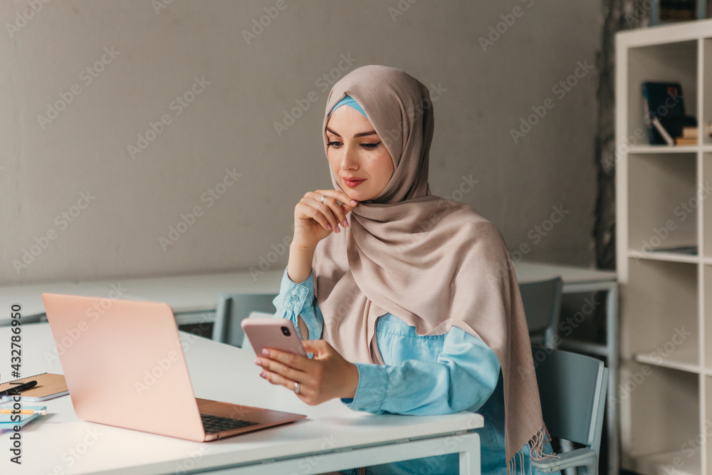 Wall mural modern muslim woman in hijab in office room