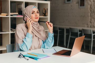modern muslim woman in hijab in office room