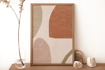 Picture frame with abstract patterned art on wooden cabinet