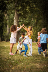 Large group of school kids having fun in nature.  Happy school age.