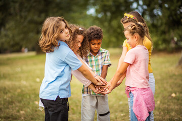Fototapeta premium School friends will be together forever. Large group of school kids having fun in nature.