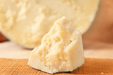 typical Italian cheese: salted pecorino romano, on a wooden cutting board, walnuts, honey, dried peaches. (sheep cheese) HD image with details for magazines, sites, social networks. kitchen restaurant