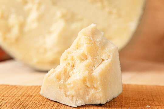 typical Italian cheese: salted pecorino romano, on a wooden cutting board, walnuts, honey, dried peaches. (sheep cheese) HD image with details for magazines, sites, social networks. kitchen restaurant