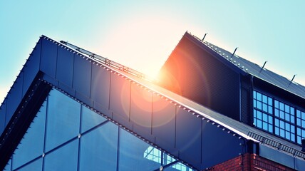 Modern building in the city with sunlight. Abstract texture and blue glass facade in modern office building., Retro stylized colorful tonal filter effect.