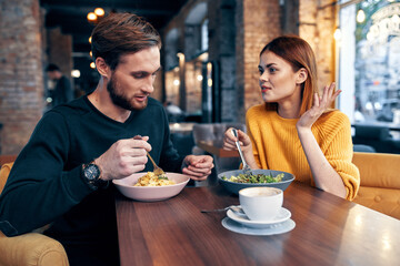 cheerful young couple in a restaurant having a snack rest lifestyle