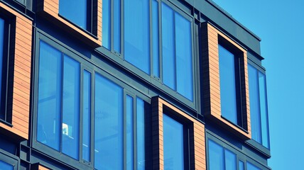 Modern building in the city with sunlight. Abstract texture and blue glass facade in modern office building., Retro stylized colorful tonal filter effect.