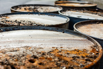 Close up of old rusty metal barrels with Sea Pocks, used as water buoys onshore