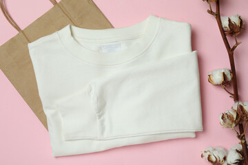 White sweatshirt, bag and cotton on pink background