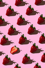 Colorful pattern of strawberries on pink background. Top view