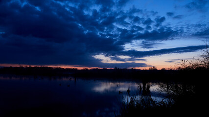 Fototapeta na wymiar landscape foto of a dawn in spring at a lake