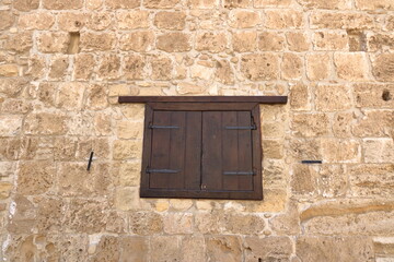 Background of decorate sand stone wall surface with wooden window