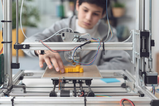 Boy Printing A Prototype Using A 3D Printer