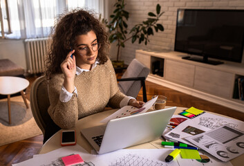 Female freelancer working from home using laptop.