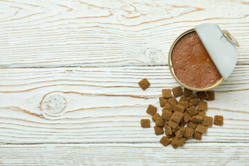 Canned food for pets on white wooden background