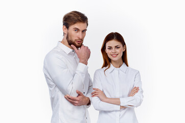 employees at work a man and a woman in identical shirts on a light background stand opposite each other
