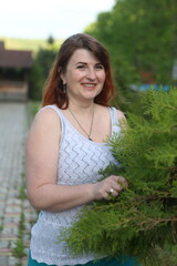 Woman near thuja in the park