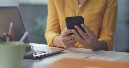 Woman sending messages with her smartphone