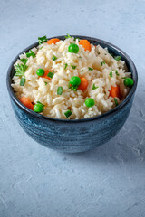 Vegan rice with copyspace. White rice with green peas, carrots etc