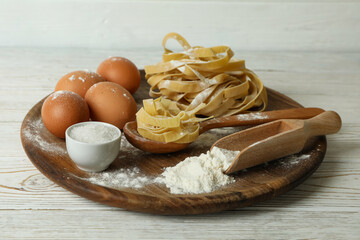 Concept of cooking pasta on white wooden background