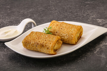 Staffed pancakes served sour cream