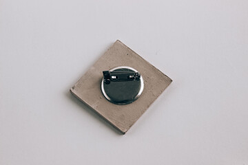 Closeup of jewelry lock mechanism, pin back closeup against white background, isolated square pin jewelry