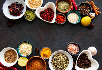 Various spices in a bowls on a black
