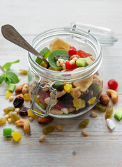 Glass jar with various dried fruits and nuts