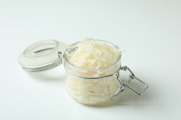 Glass jar of sauerkraut on white background