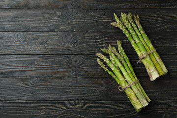 Bunches of green asparagus on wooden background