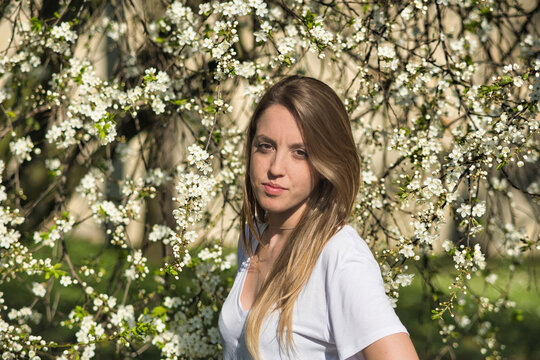 Portrait of a young girl next to an almond tree