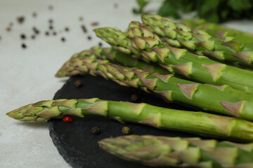 Asparagus, parsley and pepper on white textured table