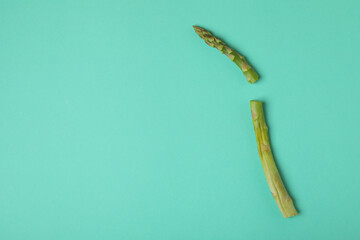 Fresh green asparagus on mint background, space for text