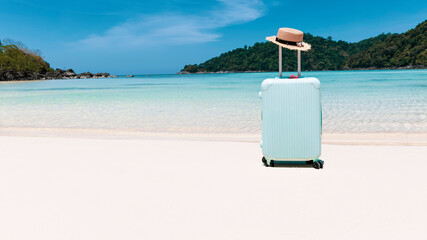 The pattern of banner travel concept with blue luggage with white sand background-vintage tone