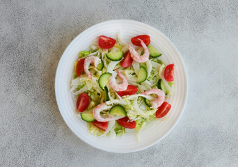 fresh summer salad of peking cabbage, cherry tomato, cucumber and shrimps