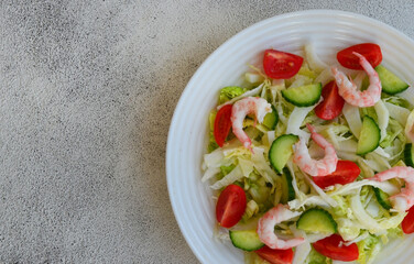 fresh summer salad of peking cabbage, cherry tomato, cucumber and shrimps