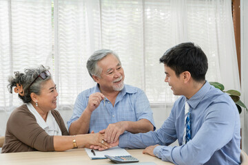 Happy senior woman hand shaking with salesman for closing deal. Old man receiving key. Business agreement contract, concept family planning future for retirement or lifestyle insurance