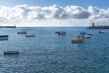 many small fishing boats and row boats in the water