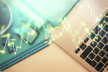 Double exposure of forex graph drawing over desktop background with computer. Concept of financial...