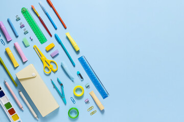Top view and flat lay of education supplies. Back to school concept with colorful stationery on yellow background