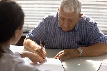 Sign here please. Sick elderly male affirming treatment plan by personal signature on appointment...