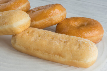 Some different donuts and cream filled buns