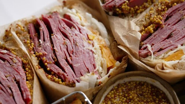 Reuben sandwich. Classic traditional American sandwich. Pastrami and corned beef on grilled bread